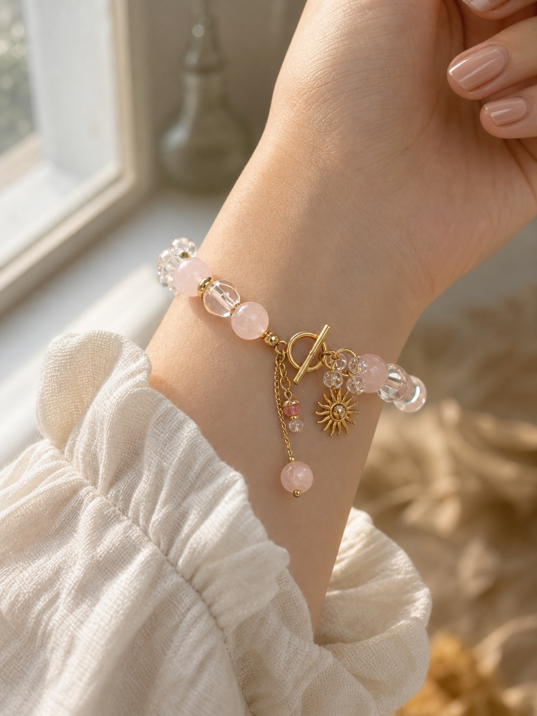 Rose quartz bracelet worn on a wrist