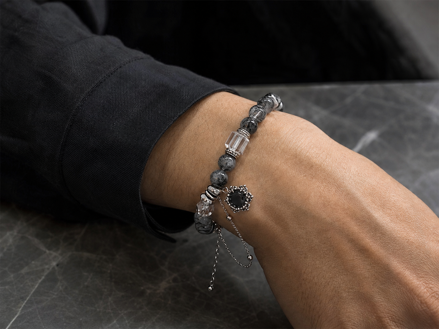 Grey black crystal bracelet worn on a wrist